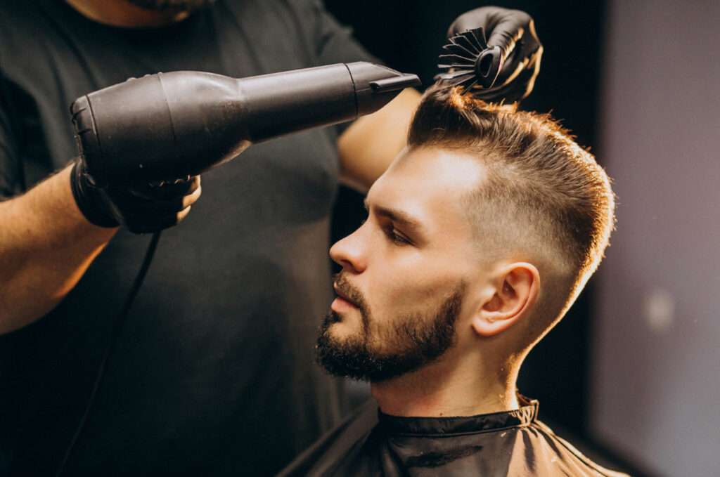 A hairdresser is making the hair straight